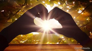 Composite image of woman making heart shape with hands